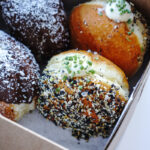 Everything Bagel Donut at mello Vancouver is a soft and fluffy brioche donut filled with a chive cream cheese filling